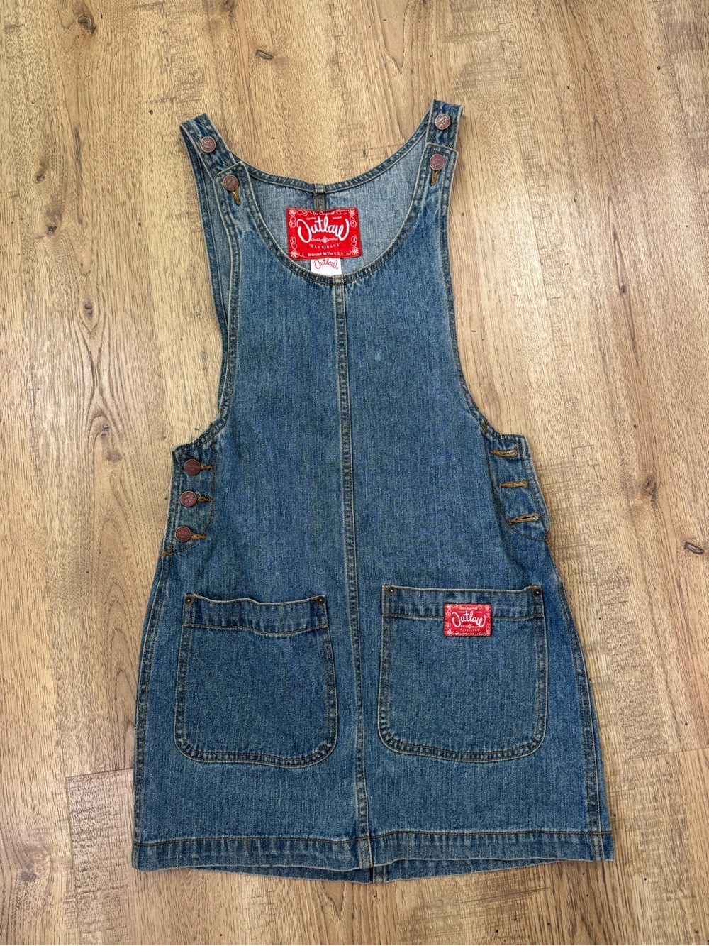vintage Outlaw denim overall dress made in the USA featuring red brand labels